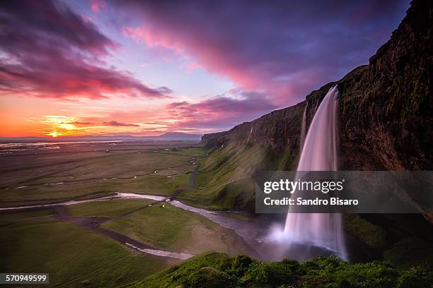 seljalandsfoss waterfall midnight sunset - midnight sun stock pictures, royalty-free photos & images