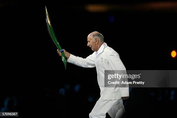 Governor of Victoria John Landy carries the Queen's Baton during the Opening Ceremony for the Melbourne 2006 Commonwealth Games at the Melbourne...