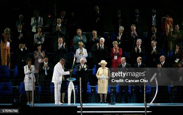 Governor of Victoria John Landy presents the Queen's Baton to Her Majesty Queen Elizabeth II during the Opening Ceremony for the Melbourne 2006...