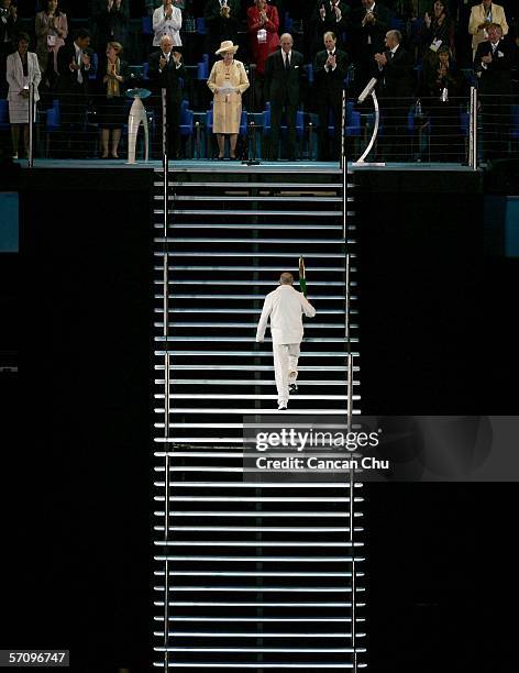 Governor of Victoria John Landy carries the Queen's Baton to Her Majesty Queen Elizabeth II during the Opening Ceremony for the Melbourne 2006...