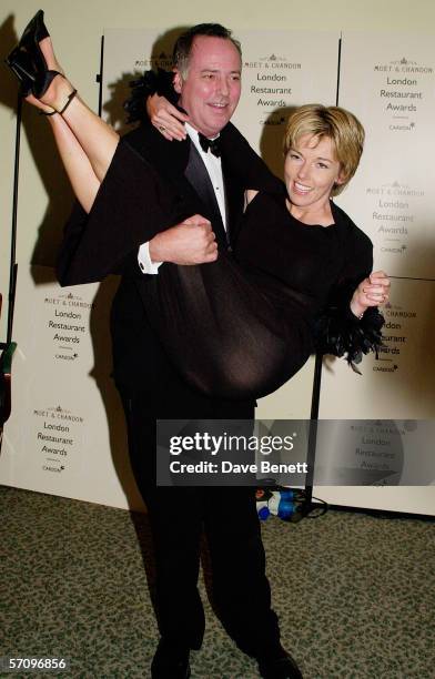 Presenter Michael Barrymore lifts up TV presenter Mary Nightingale at the Moet & Chandon Carlton TV London Restaurant Awards at the Grosvenor House...