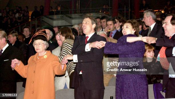 Queen Elizabeth II, British Prime Minister Tony Blair, and his wife Cherie Blair during the Millenium New Year celebrations on December 31, 1999 at...