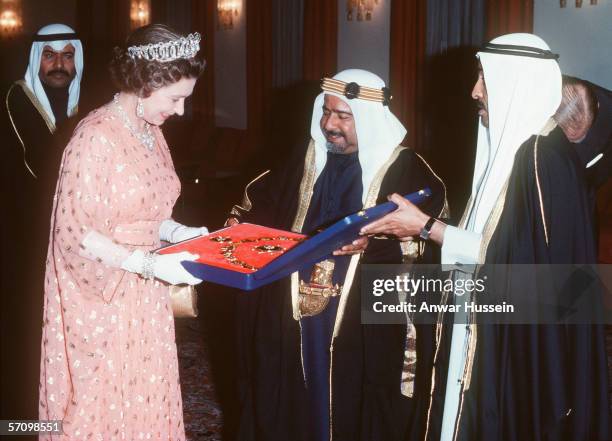 Queen Elizabeth II receives a gift from the Amir of Bahrain during her tour of the Middle East in February 1979.