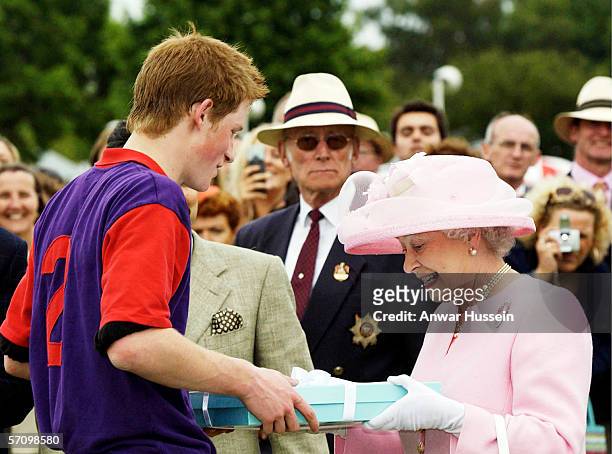 Queen Elizabeth II makes a presentation to Prince Harry after a polo match during Royal Ascot on June 18, 2003 in Windsor, England.