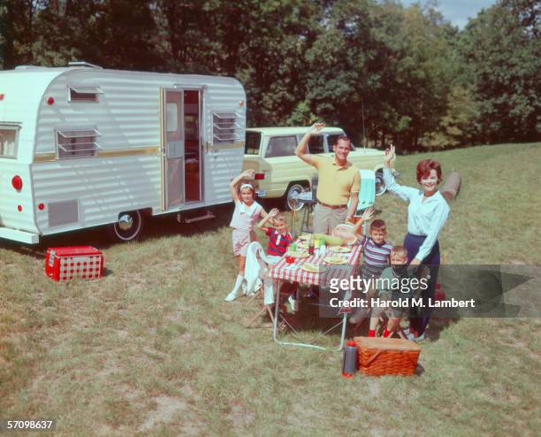 Family of six enjoy a picnic on their camping holiday, 1966.
