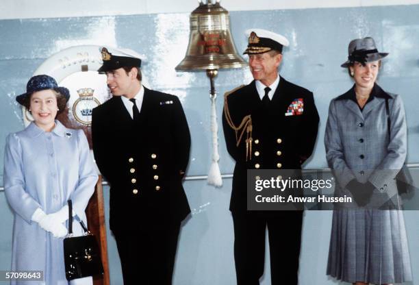 Queen Elizabeth II with Prince Andrew, the Duke of York, Prince Philip, the Duke of Edinburgh and Princess Anne, the Princess Royal on board HMS...