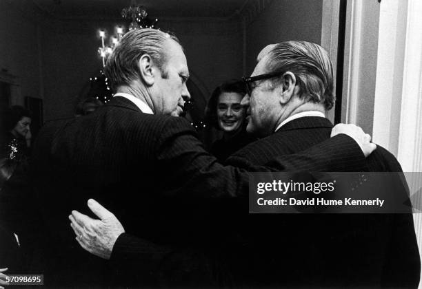 American President Gerald Ford and his Vice President Nelson Rockefeller , both in pinstripe suits, stand arm in arm at the White House, December 12,...