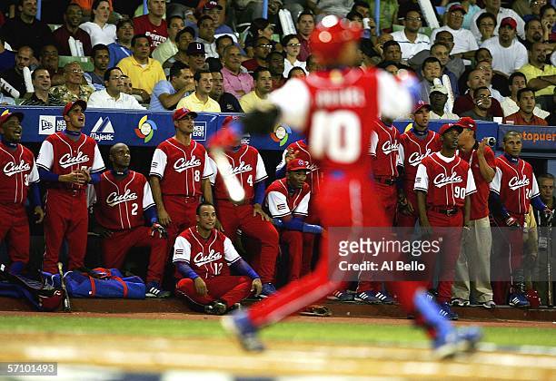 Cuban players come out of the dugout to cheer on Yulieski Gourriel of Cuba against Puerto Rico during Round 2 of the World Baseball Classic on March...