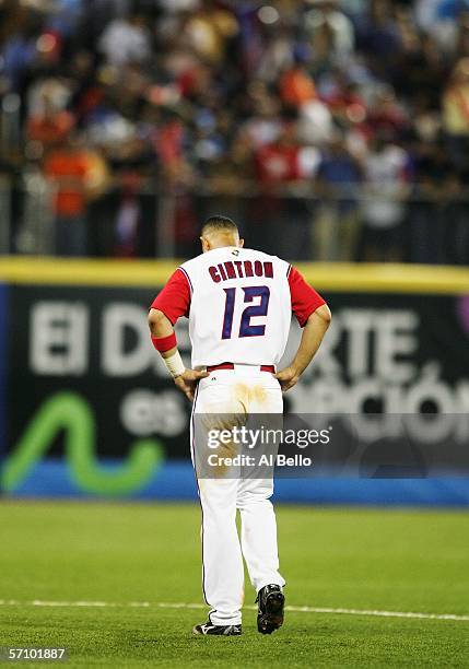 Alex Cintron of Puerto Rico hangs his head after hitting into a double play with two men in scoring position in the eighth inning against Cuba during...