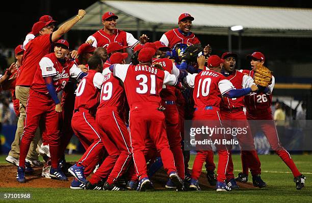 Cuba celebrates a win over Puerto Rico 4-3, advancing to the finals in the second round of the World Baseball Classic at Hiram Bithorn Stadium on...