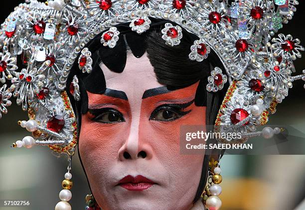 Protestor entertains people while wearing Chinese opera custume during an anti Thai Prime Minister Thaksin Shinawatra's protest rally in downtown...