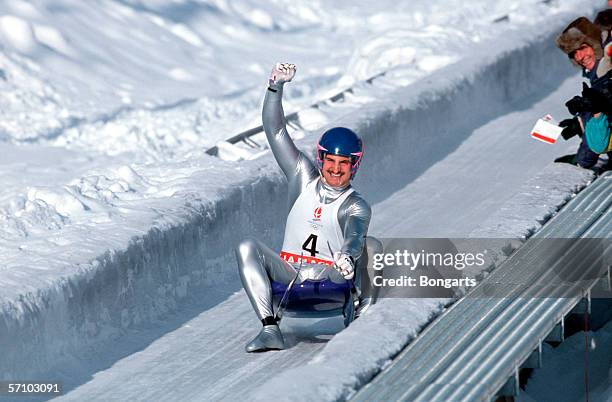 Georg Hackl of Germany celebrates after winning the gold medal during the luge competition during the Olympic Games on February 10, 1992 in...
