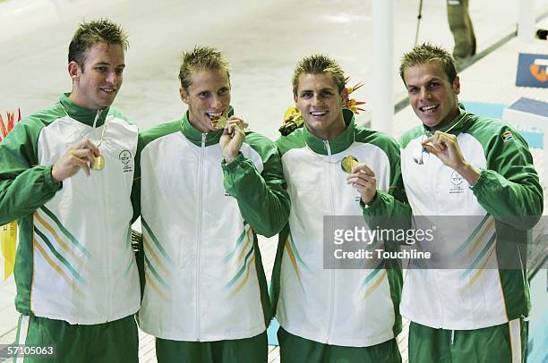 Gerhard Zandberg, Ryk Neethling, Lyndon Ferns and Roland Schoeman of South Africa celebrate victory in the 4x100m freestyle relay at the Melbourne...