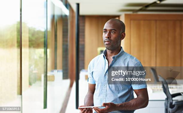 architect in a modern office contemplating project - black shirt stock pictures, royalty-free photos & images