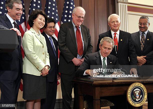 Washington, UNITED STATES: US President, George W. Bush signs the Stop Counterfeiting in Manufactured Goods Act as US Secretary of Commerce, Carlos...