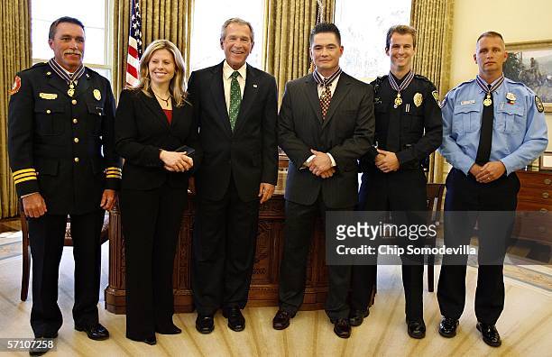 President George W. Bush stands with the recipients of The Public Safety Officer Medals of Valor Fort Walton Beach, FL, Battalion Chief Gene Large,...