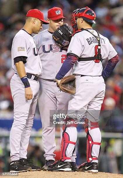 Starting pitcher Roger Clemens of Team USA talks with teammates Michael Barrett and Derek Jeter on the mound during the first inning of the Round 2,...