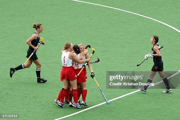 Louise Kate Walsh, Melanie Clewlow and Jennie Bimson of England celebrate a goal during the Women's Hockey match between England and Canada during...