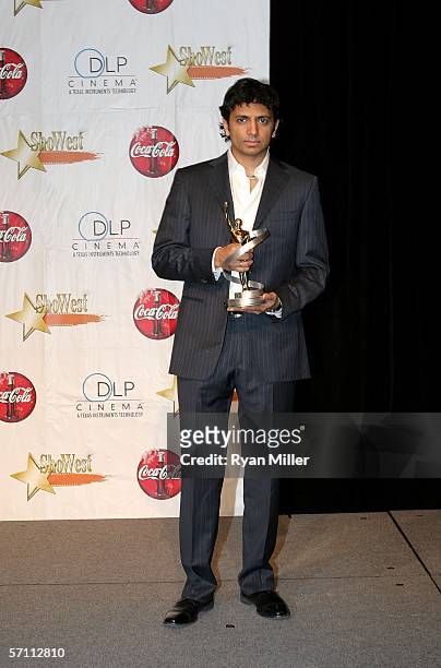 Director M. Night Shyamalan poses with the Director of the Year award at the Paris Las Vegas during ShoWest 2006, the official convention of the...