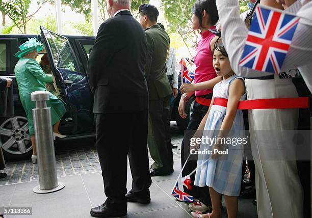 Queen Elizabeth II steps into her car after visiting the National Library on March 17, 2006 in Singapore.The monarch arrived in Singapore yesterday...