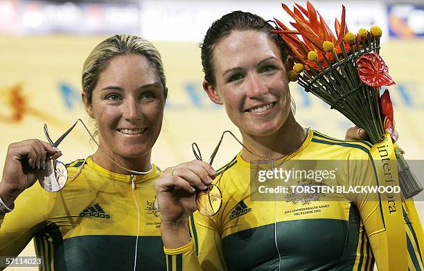Australia's Katherin Bates displays her gold medal with silver medallist and compatriot Rochelle Gilmore after the cycling final of the women's 25km...