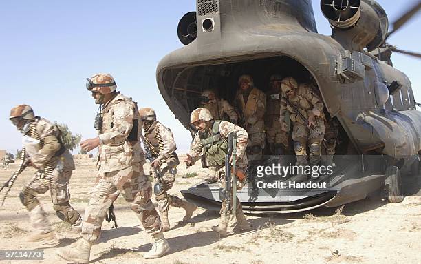 In this U.S. Military handout, Iraqi Army Soldiers from 4th Iraqi Army Division leave a CH-47 Chinook helicopter during of Operation Swarmer March 16...