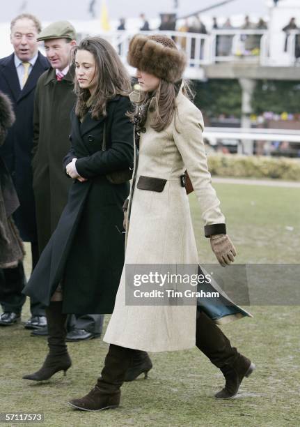 Pippa Middleton and Prince William's girlfriend Kate Middleton, wearing a Russian-style fur hat, attend the final day of Cheltenham Races on March...