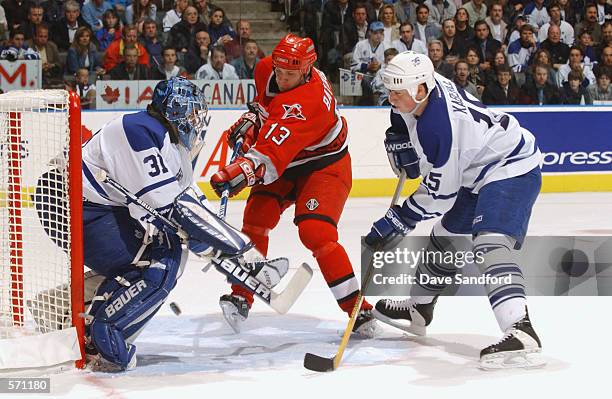 Bates Battaglia of the Carolina Hurricanes is stopped on this scoring attempt by Curtis Joseph of the Toronto Maple Leafs during game four of the...