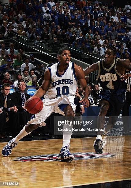 Rodney Carney of the Memphis Tigers drives past Larry Owens of the Oral Roberts Golden Eagles during the First Round game of the 2006 NCAA Division 1...