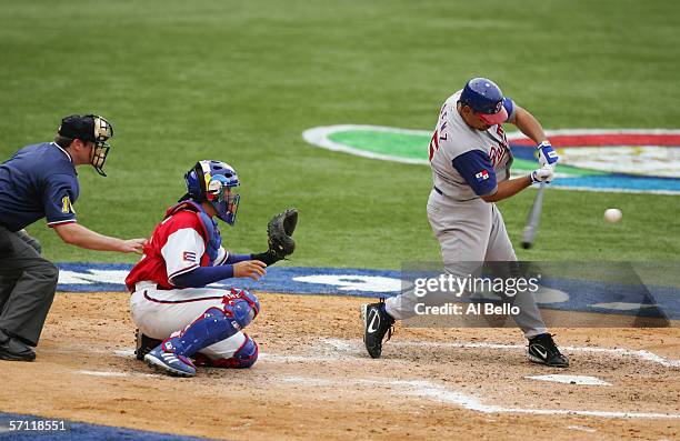 Olmedo Saenz of Panama swings at the pitch against Cuba during the World Baseball Classic at Hiram Bithorn Stadium on March 8, 2006 in San Juan,...