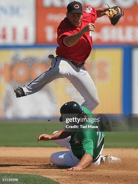 Ryan Freel of the Cincinnati Reds turns a double play as Troy Glaus of the Toronto Blue Jays is out sliding into second base during their Spring...