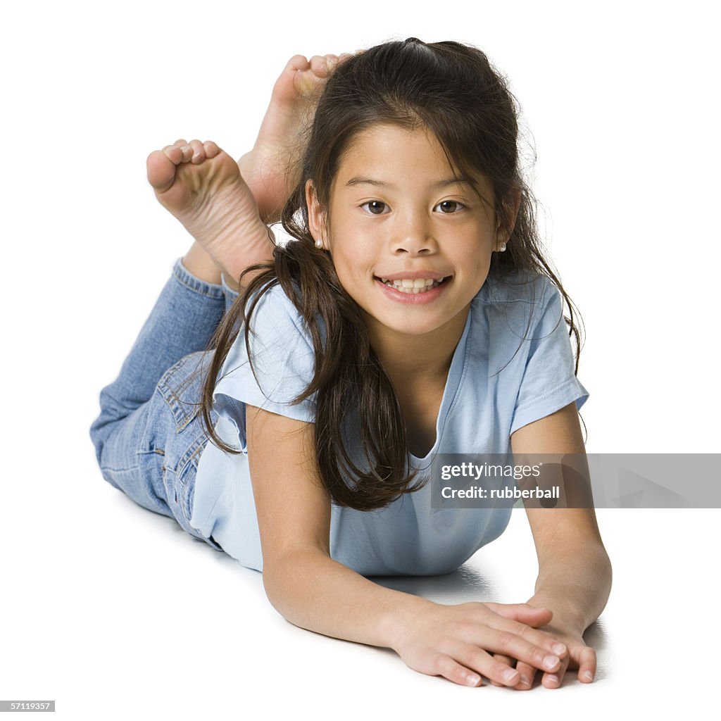 Portrait of a girl lying on the floor and smiling