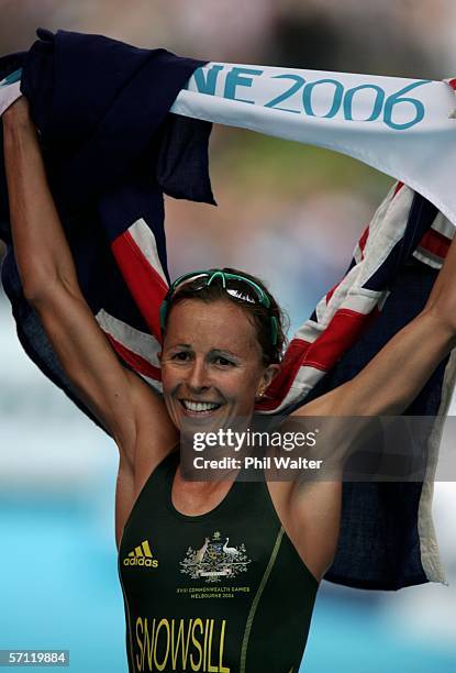 Emma Snowsill of Australia celebrates as she wins gold in the Triathlon Women's Race at the St Kilda Foreshore and Beach Road during day three of the...