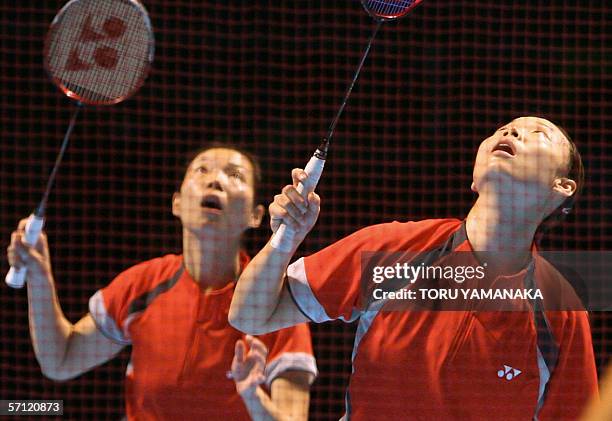 Singapore badminton players Li Yujia and Jiang Yanmei look up at the shuttlecocs for a return against Karen Foo Kune and Marlyse Marquer of Mauritius...