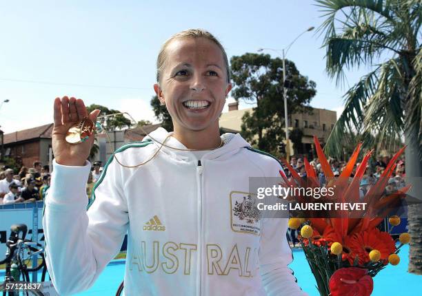 Australian Emma Snowsill shows her gold medal for the women's triathlon event during the Commonwealth Games in Melbourne, 18 March 2006. Snowsill won...