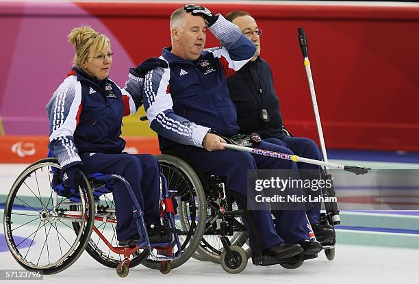 Angie Malone commiserates with Great Britian team mate Frank Duffy after the Wheelchair Curling Final between Great Britain and Canada during Day...