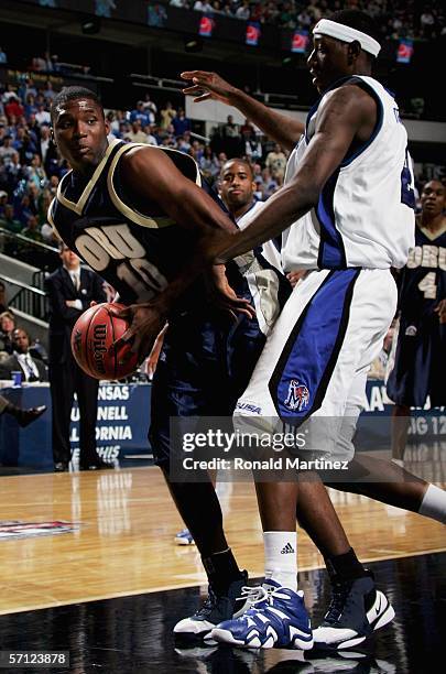 Marchello Vealy of the Oral Roberts Golden Eagles drives past Robert Dozier of the Memphis Tigers during the First Round game of the 2006 NCAA...