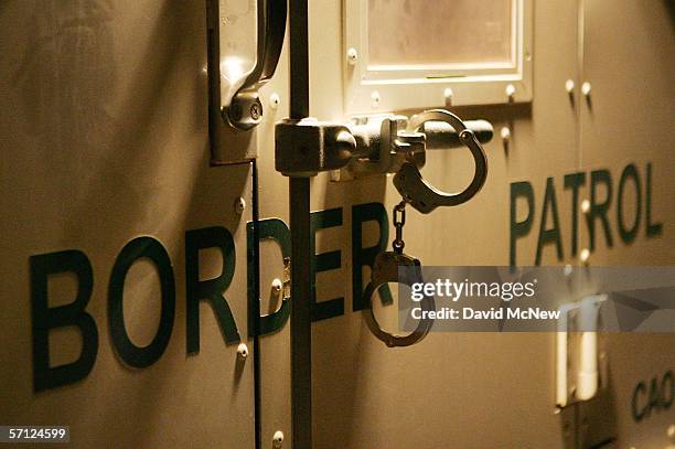 Handcuffs secure the back door of a US Customs and Border Protection border patrol vehicle loaded with suspected illegal immigrants on the California...