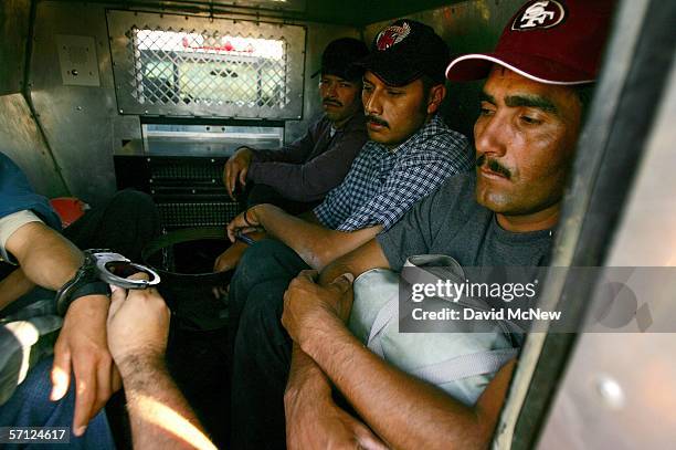 Handcuffs are removed from a suspected illegal immigrant as he is placed in the back of a U.S. Customs and Border Protection border patrol vehicle...