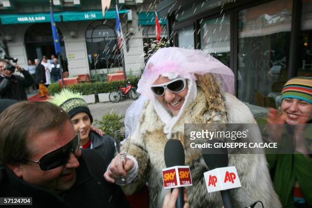 Two men dressed as a bride and groom are interviewed by journalists in Cernobbio, 18 March 2006. US film stars Brad Pitt and Angelina Jolie are...