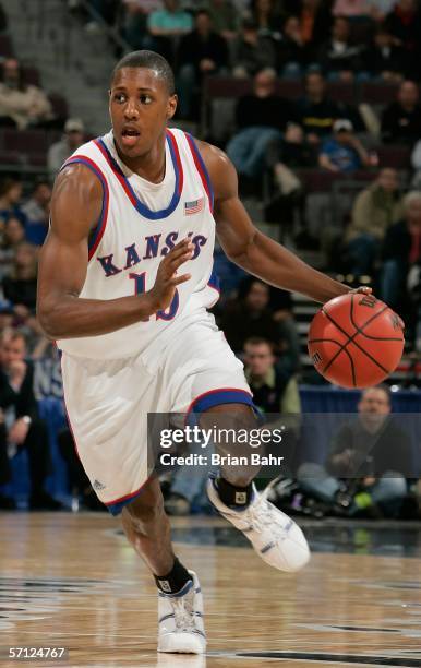 Mario Chalmers of the Kansas Jayhawks dribbles against the defense of the Bradley Braves during the First Round of the 2006 NCAA Men's Basketball...