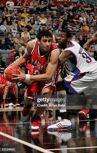 Tauai of the Bradley Braves moves against the defense of Julian Wright of the Kansas Jayhawks during the First Round of the 2006 NCAA Men's...