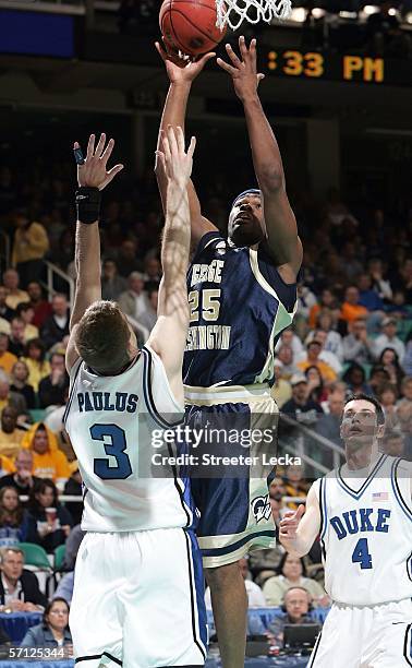 Carl Elliott of the George Washington Colonials shoots over Greg Paulus of the Duke Blue Devils during the Second Round of the 2006 NCAA Men's...