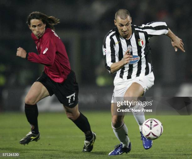 Zlatan Ibrahimovic of Juventus evades Alessandro Grandoni of Livorno during the Serie A match between Livorno and Juventus at the Stadio Armando...