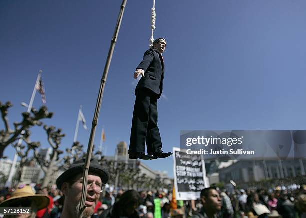 An anti-war demonstrator hangs a doll that represents the U.S. President George W. Bush from a stick during an anti-war demonstration March 18, 2006...