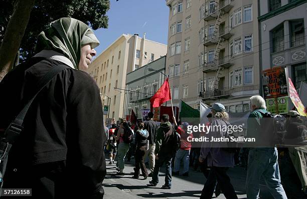 Woman looks on as anti-war demonstrators march through the streets March 18, 2006 in San Francisco, California. Thousands took to the streets to mark...