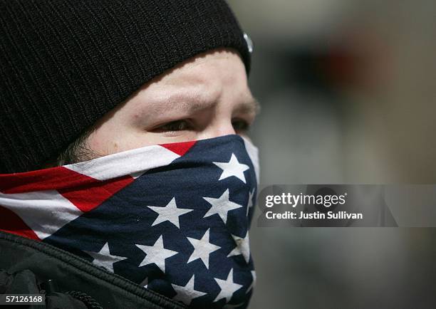 Demonstrator covers his face with an American flag bandana during an anti-war demonstration March 18, 2006 in San Francisco, California. Thousands...