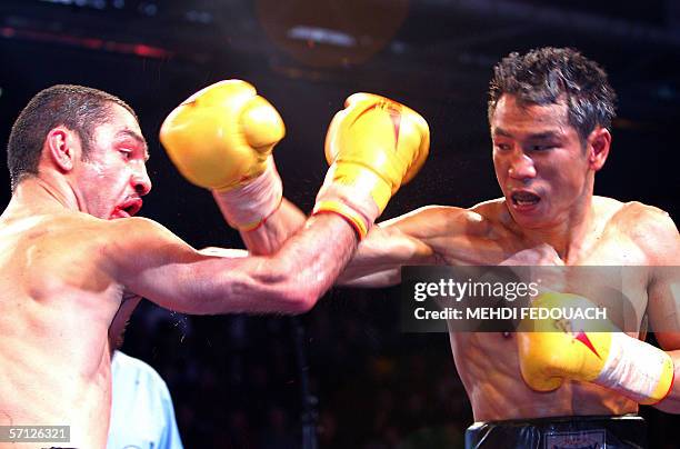 Levallois-Perret, FRANCE: Thai boxer Somsak Sithchatchawal hits French boxer Mahyar Monshipour during their WBA super bantamweight fight, 18 March...