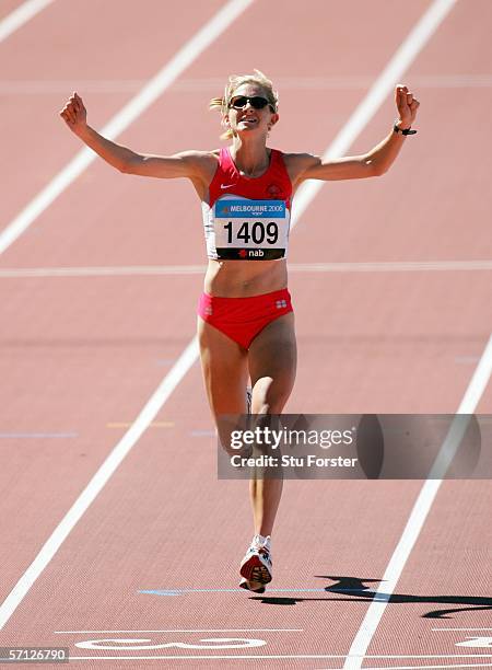 Liz Yelling of England reacts after she crosses the finish line third in the women's marathon at the athletics during day four of the Melbourne 2006...