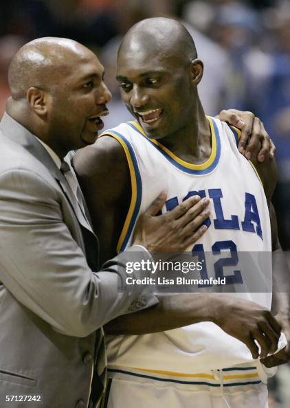 Alfred Aboya of the UCLA Bruins celebrates with assistant coach Ernie